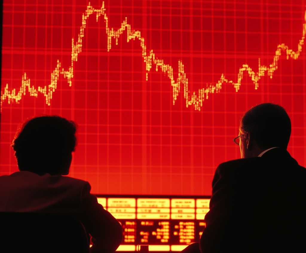 Investors analyzing market performance data on a large display